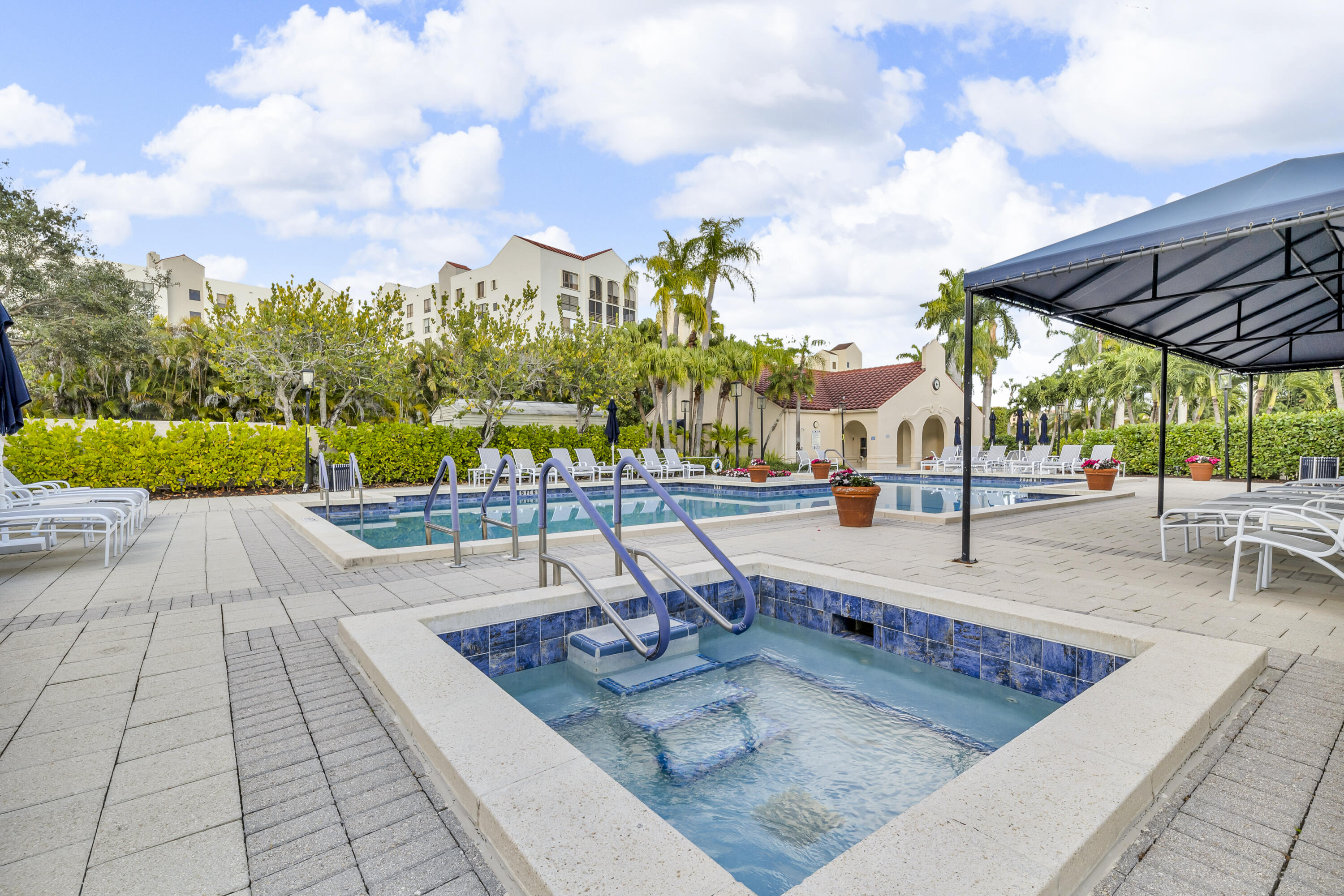7572 Regency Lake Drive, Unit 402 Boca Raton, FL 33433 - Photo 30 of 31 a view of a swimming pool with a patio