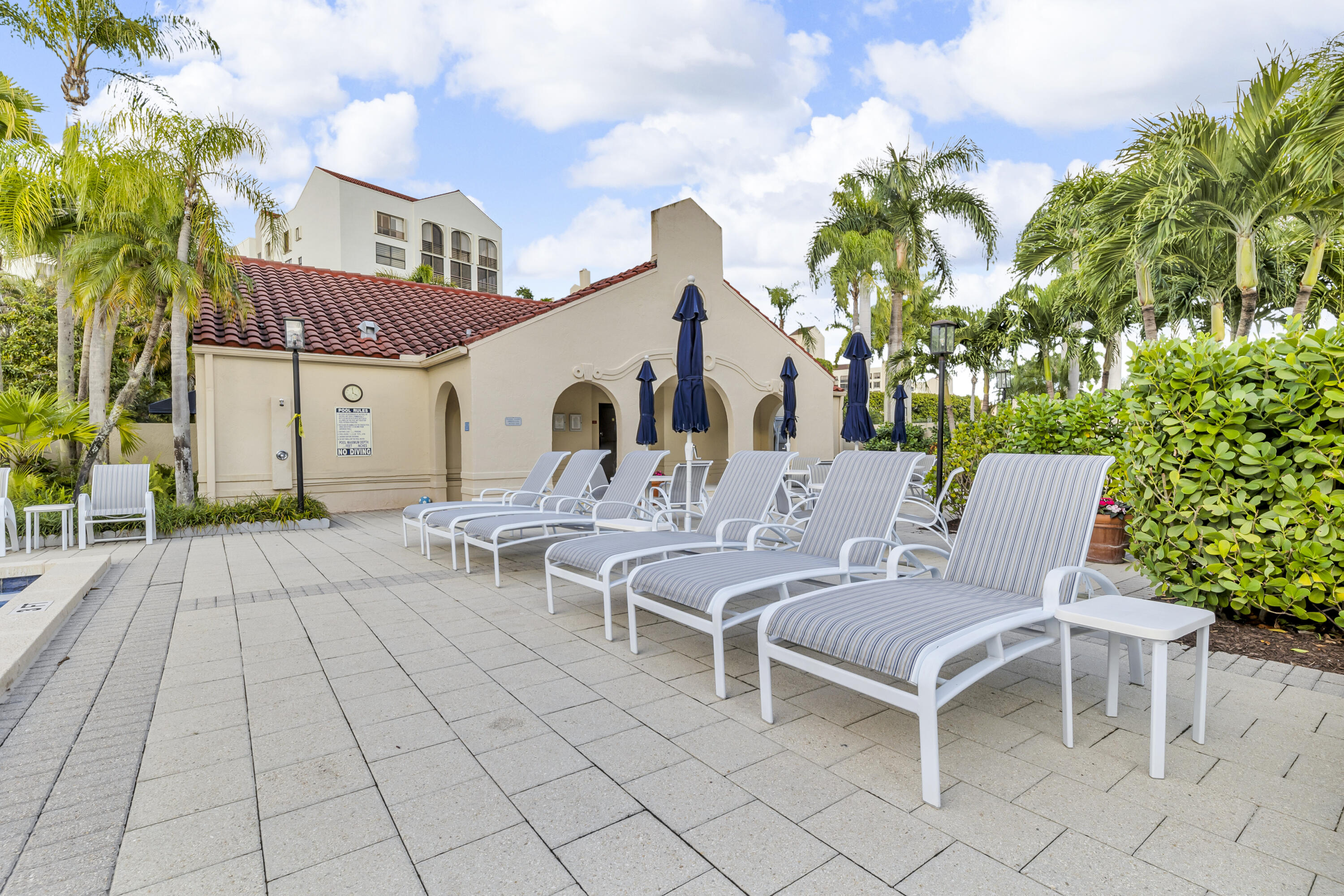 7572 Regency Lake Drive, Unit 402 Boca Raton, FL 33433 - Photo 31 of 31 a view of a patio with a table and chairs