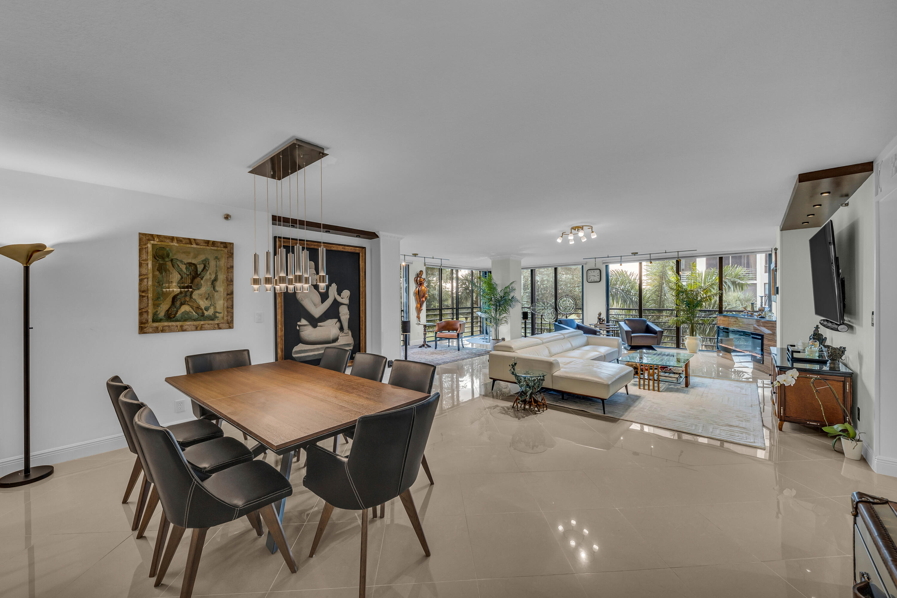 7572 Regency Lake Drive, Unit 402 Boca Raton, FL 33433 - Photo 4 of 31 a living room with furniture a flat screen tv and a large window
