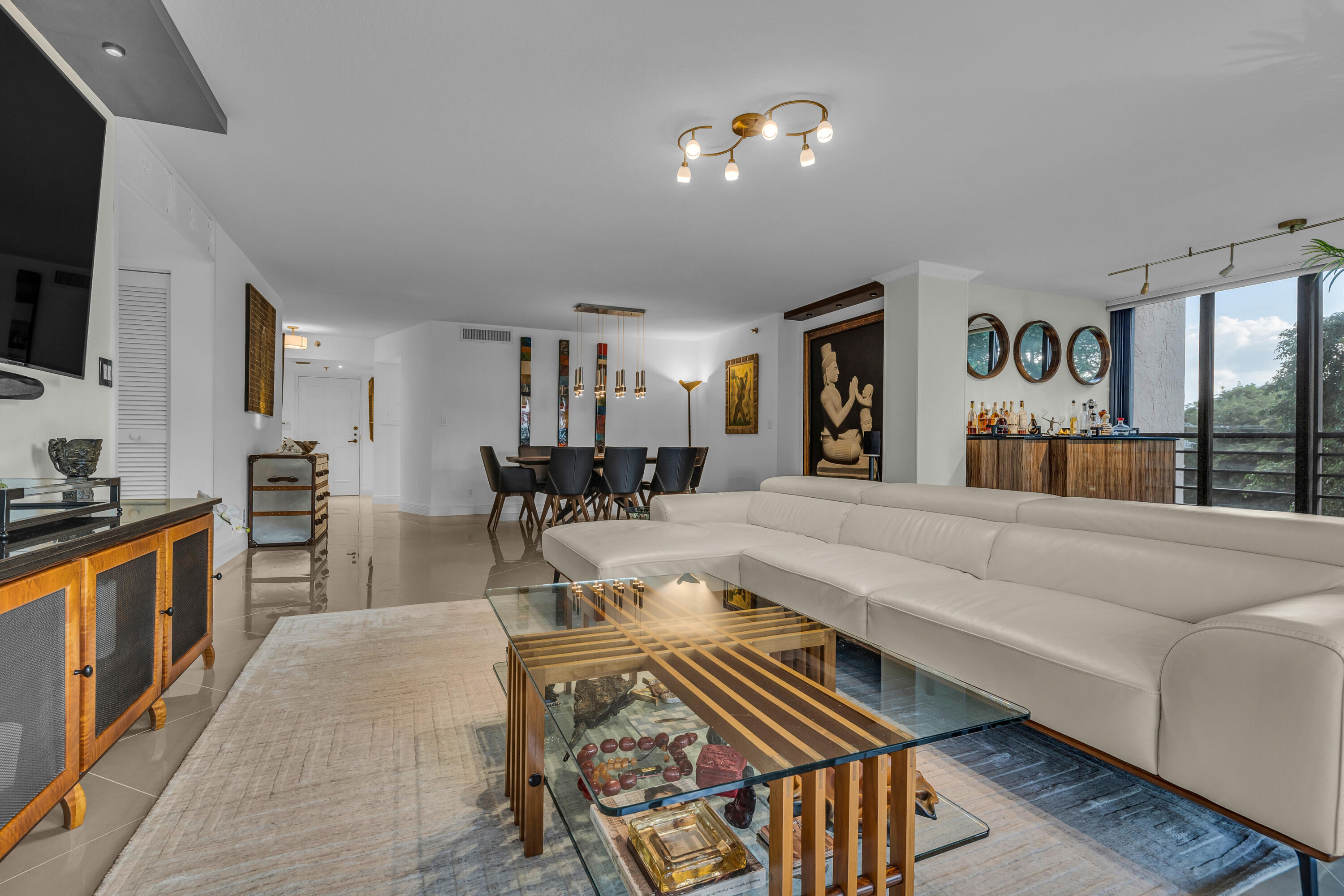 7572 Regency Lake Drive, Unit 402 Boca Raton, FL 33433 - Photo 5 of 31 a living room with furniture fireplace and flat screen tv