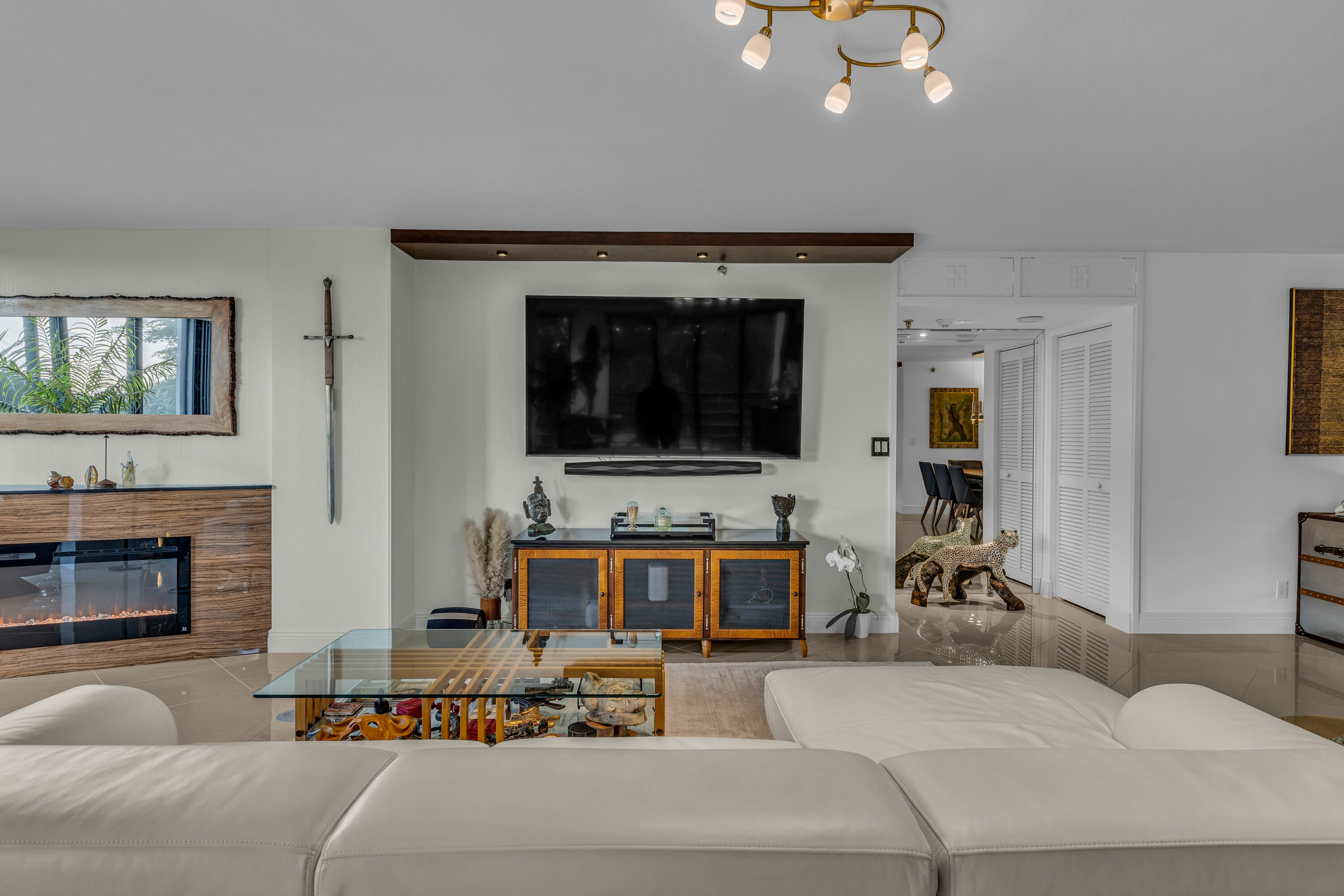 7572 Regency Lake Drive, Unit 402 Boca Raton, FL 33433 - Photo 6 of 31 a living room with furniture and a fireplace