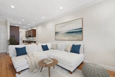a living room with furniture and a painting