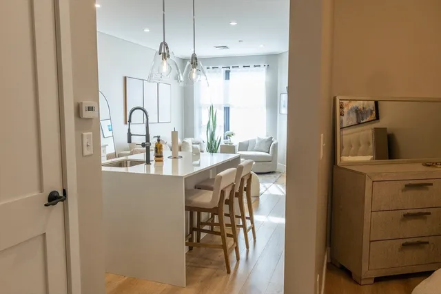 a kitchen with a table chairs refrigerator and cabinets