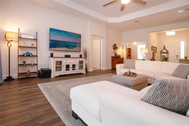 a kitchen with white cabinets stainless steel appliances and wooden floor