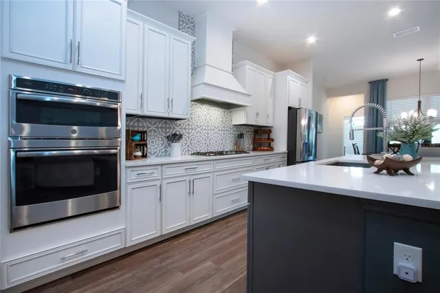 a living room with furniture and a view of kitchen