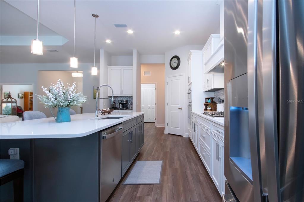 4304 Fly Rod Terrace Parrish, FL 34219 - Photo 23 of 97 a kitchen with kitchen island granite countertop a sink stove and cabinets