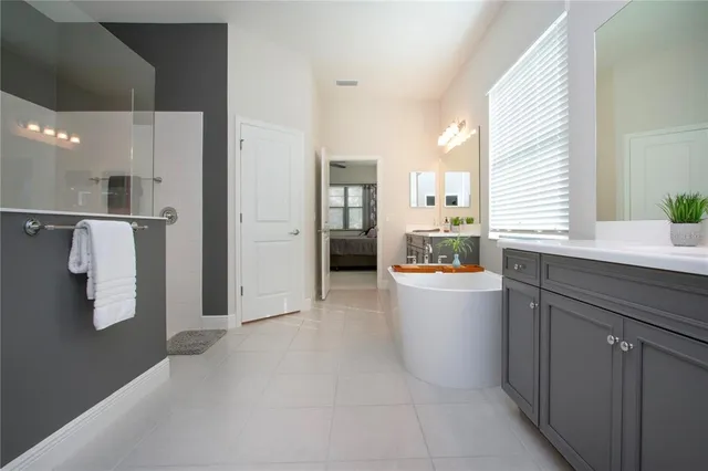 an aerial view of a house with outdoor space and lake view in back