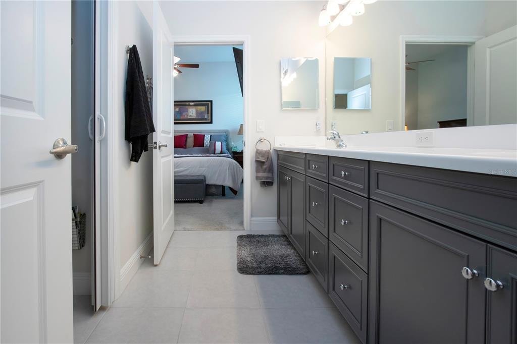 4304 Fly Rod Terrace Parrish, FL 34219 - Photo 42 of 97 a en suite bathroom with a double vanity sink and a mirror