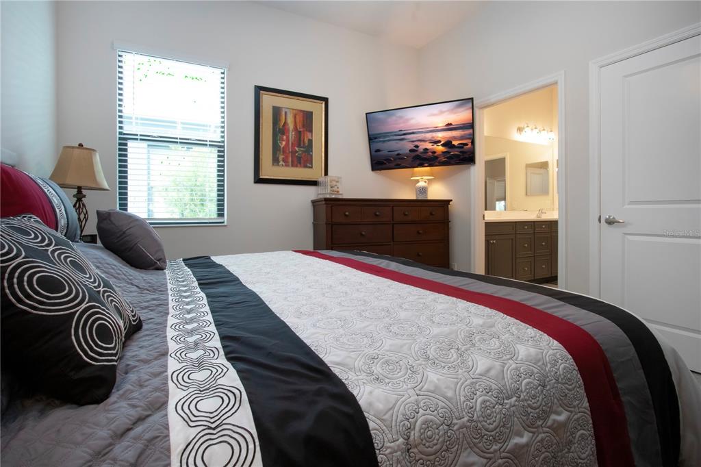 4304 Fly Rod Terrace Parrish, FL 34219 - Photo 47 of 97 a bedroom with a bed and a flat screen tv