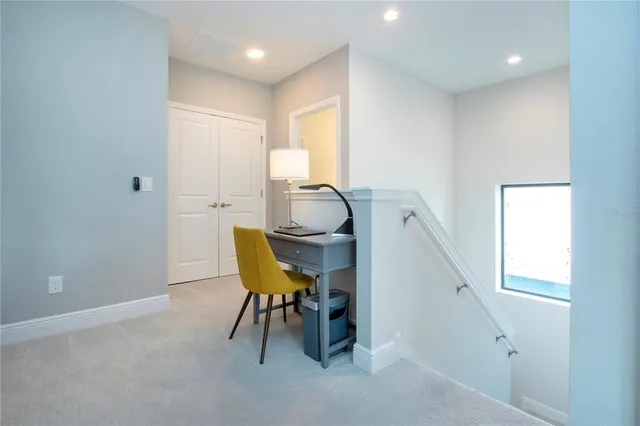 a view of a house with swimming pool and sitting area