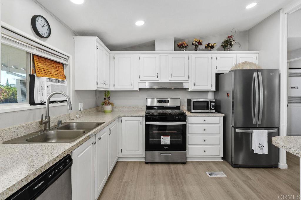 530 West Devonshire Avenue, Unit 84 Hemet, CA 92543 - Photo 18 of 36 a kitchen with granite countertop a refrigerator and a sink