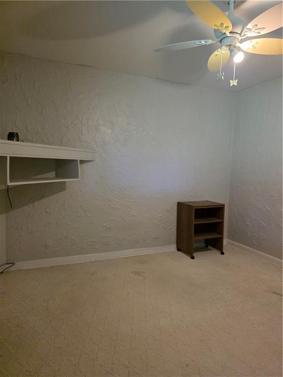 1356 Connellsville Road Lemont Furnace, PA 15456 - Photo 11 of 29 a room with a empty space and empty racks