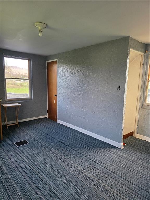 1356 Connellsville Road Lemont Furnace, PA 15456 - Photo 22 of 29 an empty room with wooden floor and windows