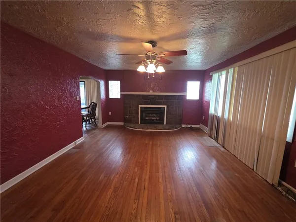 wooden floor in an empty room with a fireplace