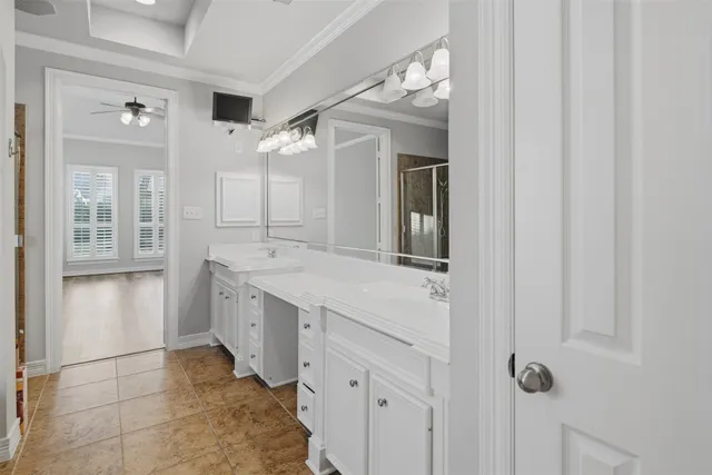 a spacious bathroom with a double vanity sink and a mirror