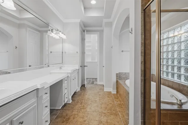 a spacious bathroom with a double vanity sink a mirror and a shower