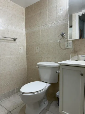 a white toilet sitting next to a bathroom sink