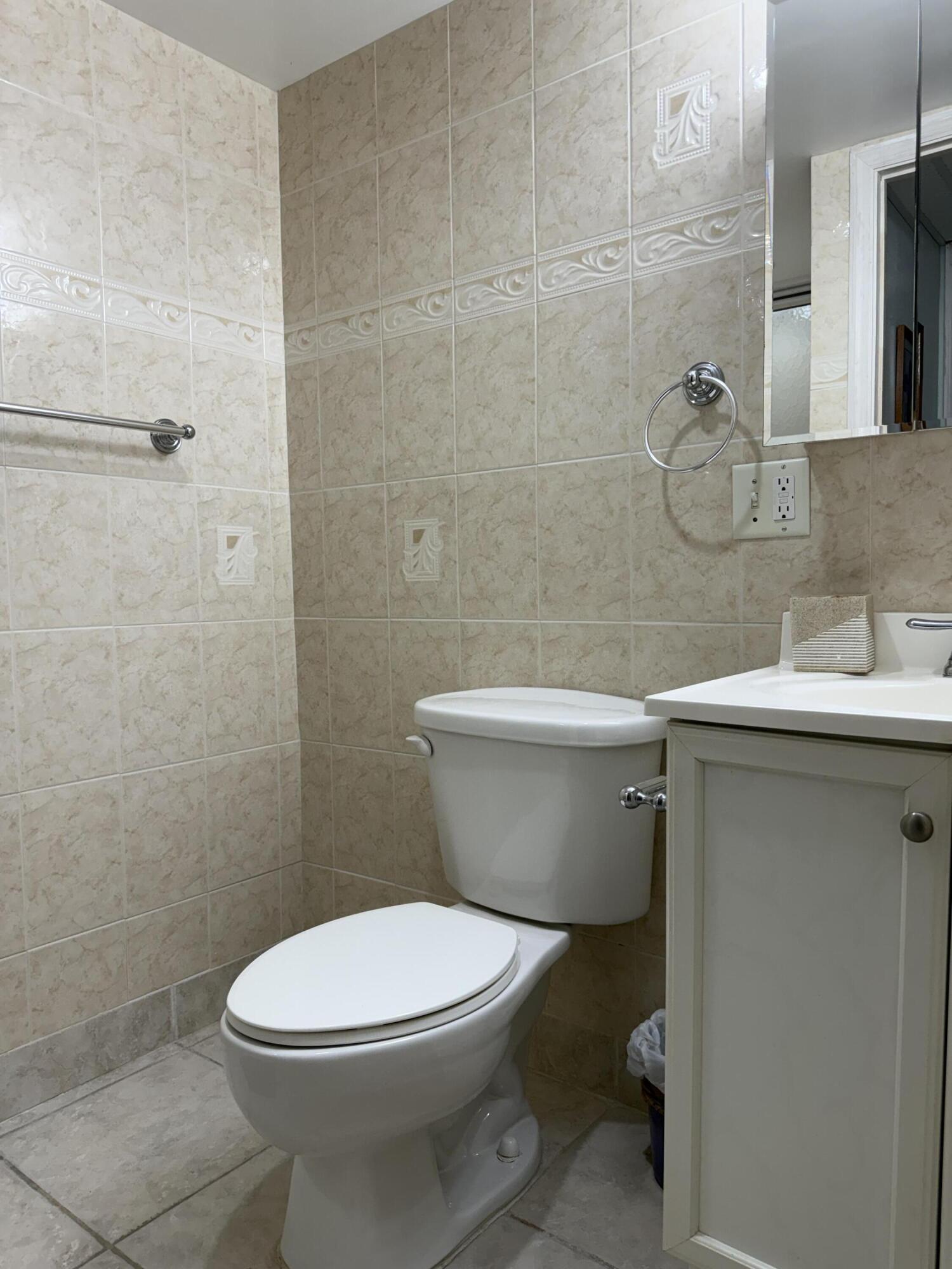 337 Saxony Lane Delray Beach, FL 33446 - Photo 15 of 26 a white toilet sitting next to a bathroom sink