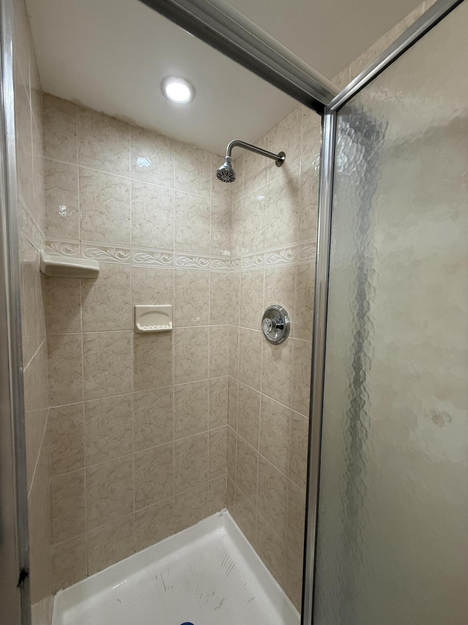 337 Saxony Lane Delray Beach, FL 33446 - Photo 16 of 26 a bathroom with a shower
