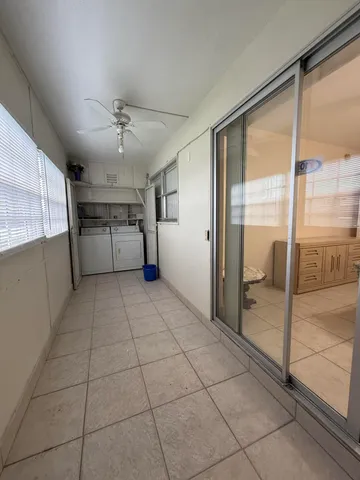a view of a refrigerator in kitchen and a window