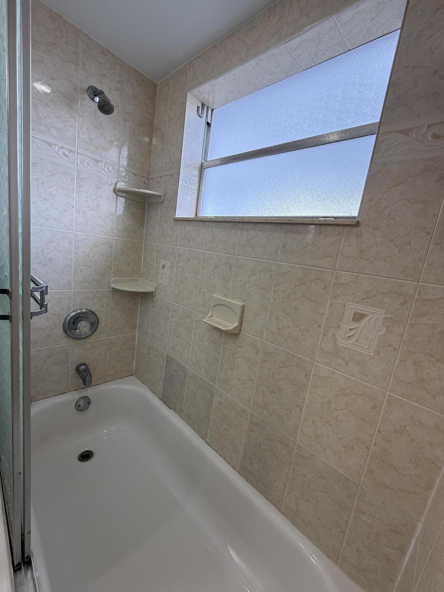 337 Saxony Lane Delray Beach, FL 33446 - Photo 10 of 26 a bathroom with a shower