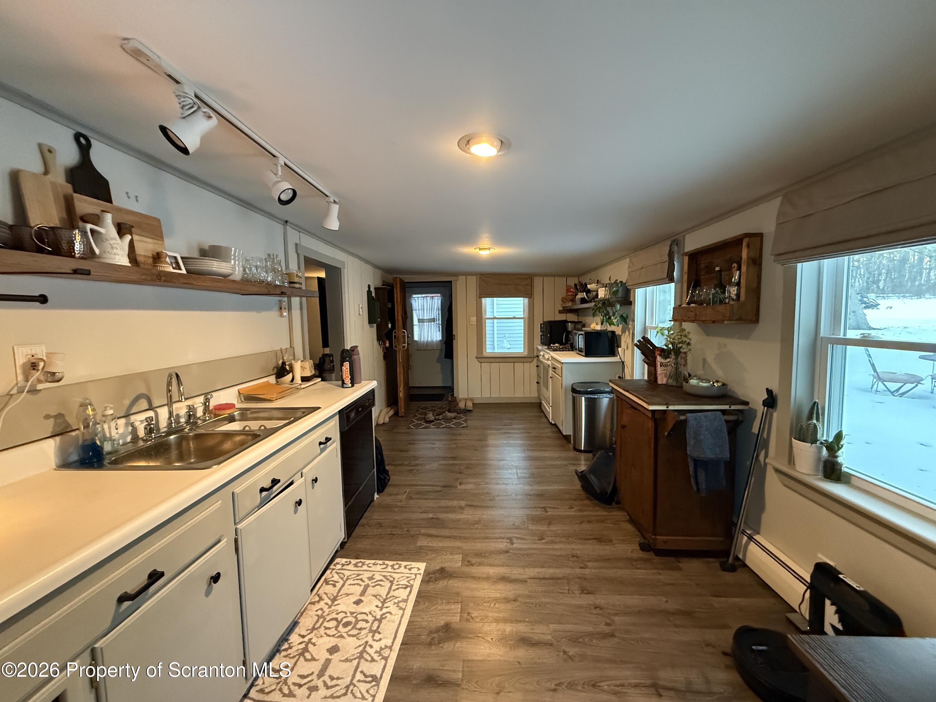 155 Hickory Hill Road Starrucca, PA 18462 - Photo 14 of 46 a large kitchen with stainless steel appliances granite countertop a lot of counter space and wooden floors