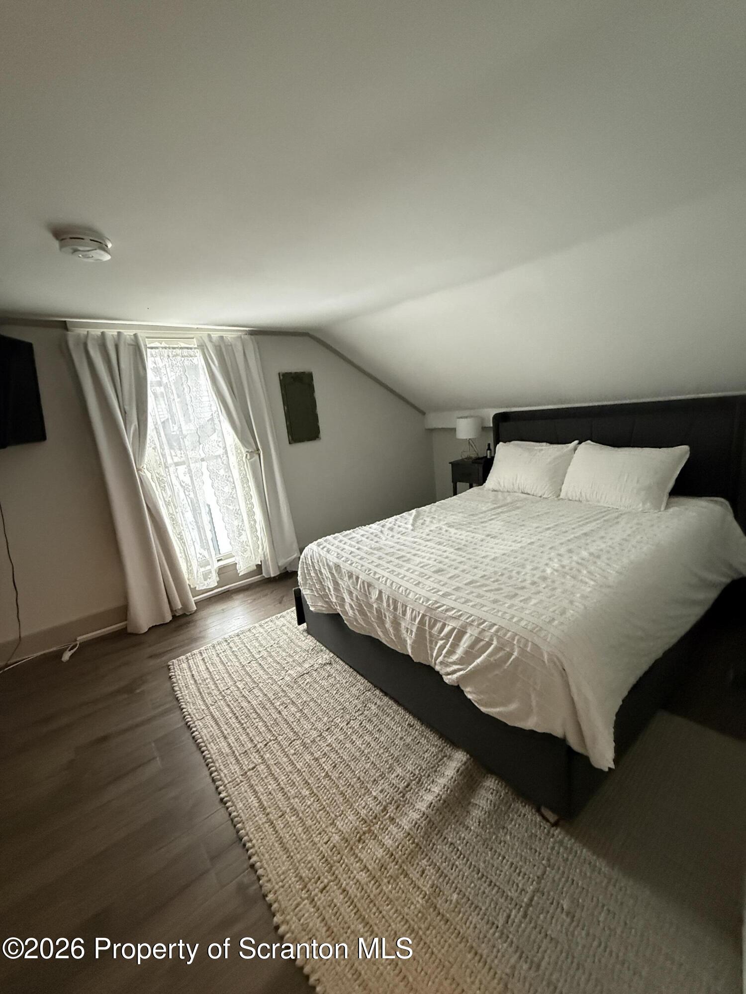 155 Hickory Hill Road Starrucca, PA 18462 - Photo 17 of 46 a bedroom with a large bed and a walk in closet