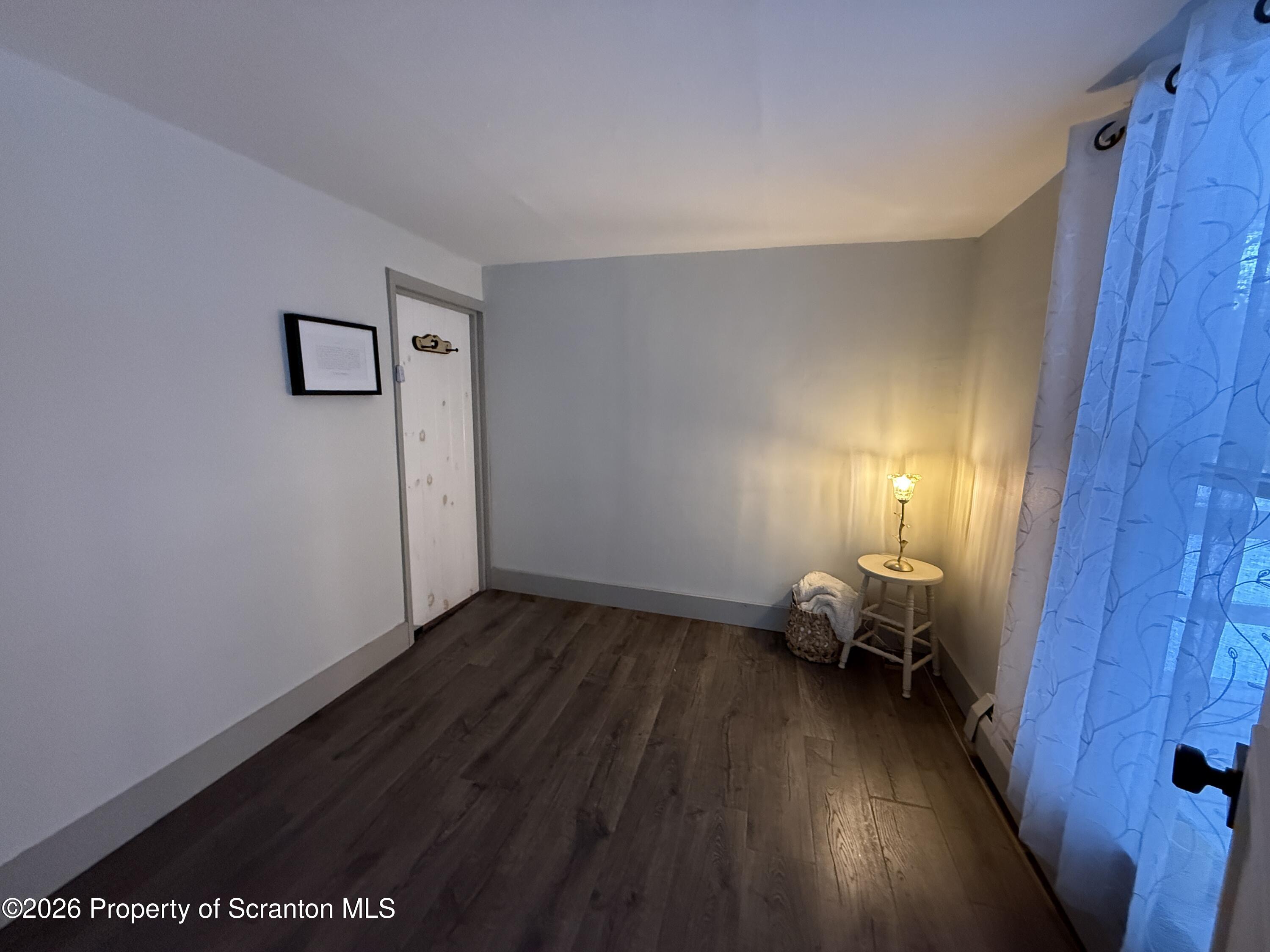 155 Hickory Hill Road Starrucca, PA 18462 - Photo 21 of 46 a view of a room with wooden floor lounge chair and windows