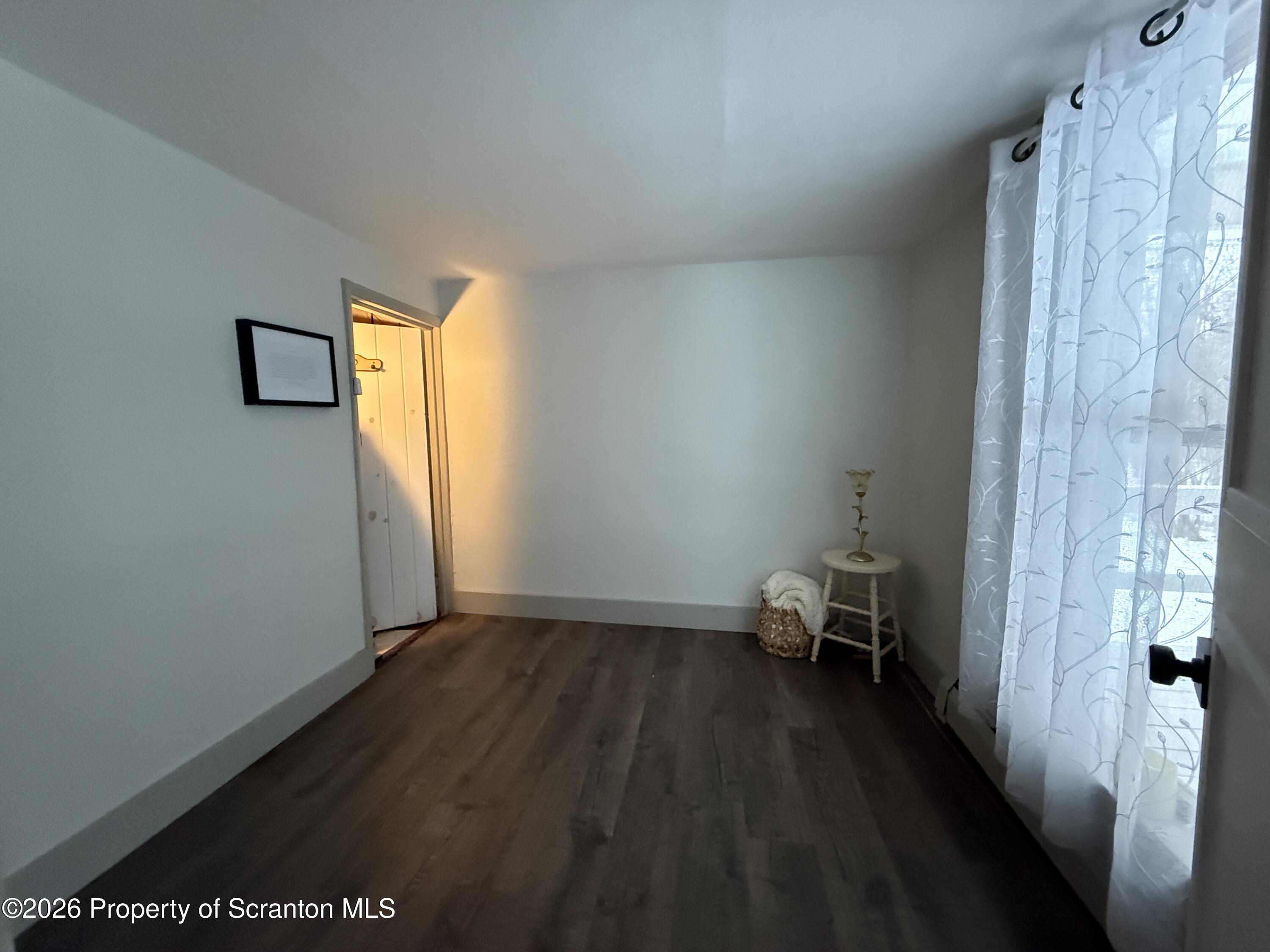 155 Hickory Hill Road Starrucca, PA 18462 - Photo 22 of 46 a view of a room with wooden floor and a window