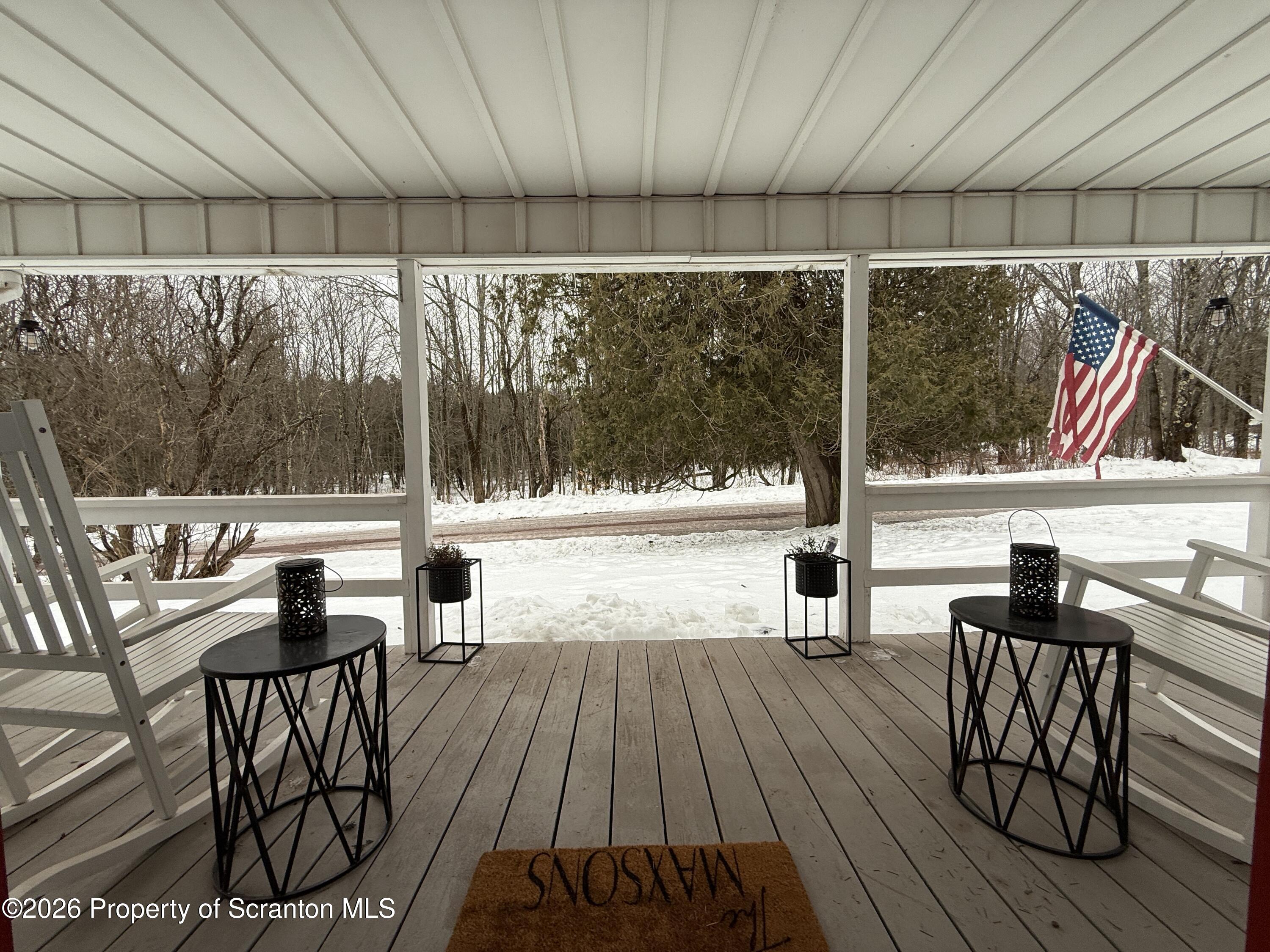 155 Hickory Hill Road Starrucca, PA 18462 - Photo 4 of 46 a view of a chairs and table in patio with wooden floor