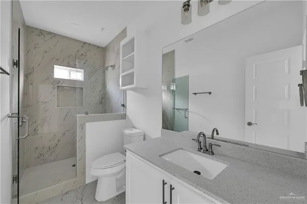 a bathroom with a sink toilet and shower