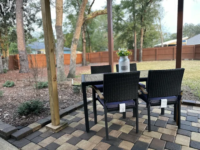 a view of a patio with table and chairs and potted plants