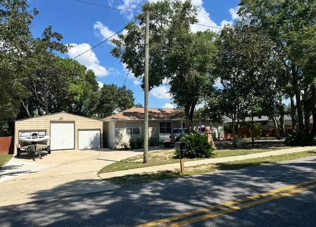 a front view of a house with a garden