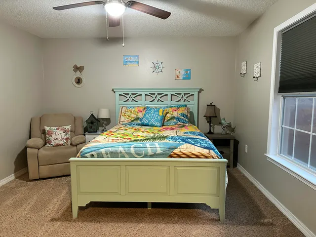 a bedroom with a bed and flat screen tv