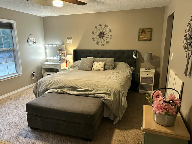a bedroom with a bed and window