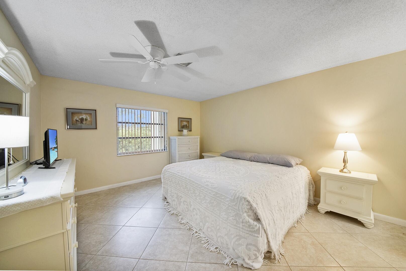 5222 Privet Place, Unit B Delray Beach, FL 33484 - Photo 15 of 27 a bedroom with a bed and a desk
