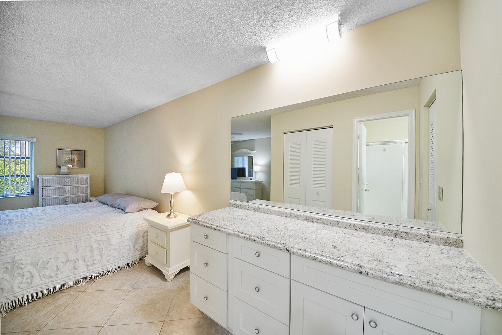 5222 Privet Place, Unit B Delray Beach, FL 33484 - Photo 16 of 27 a bedroom with a bed and window