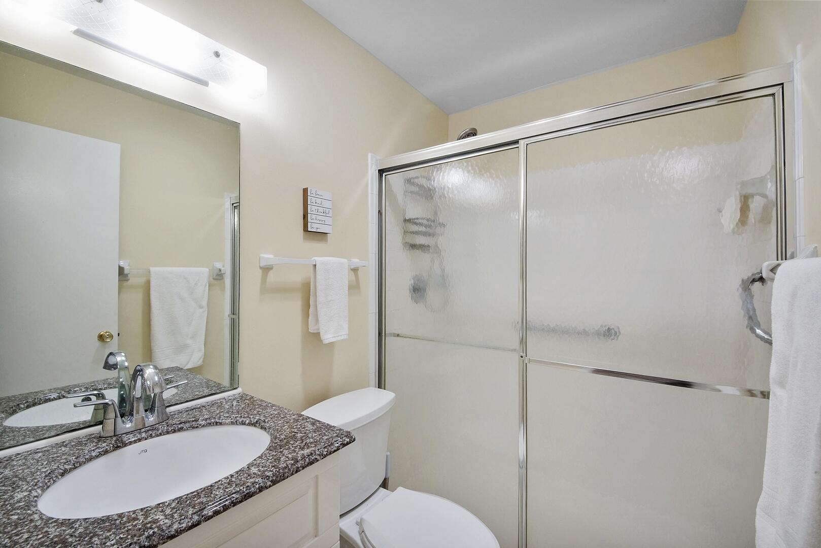 5222 Privet Place, Unit B Delray Beach, FL 33484 - Photo 18 of 27 a bathroom with a granite countertop sink toilet and shower