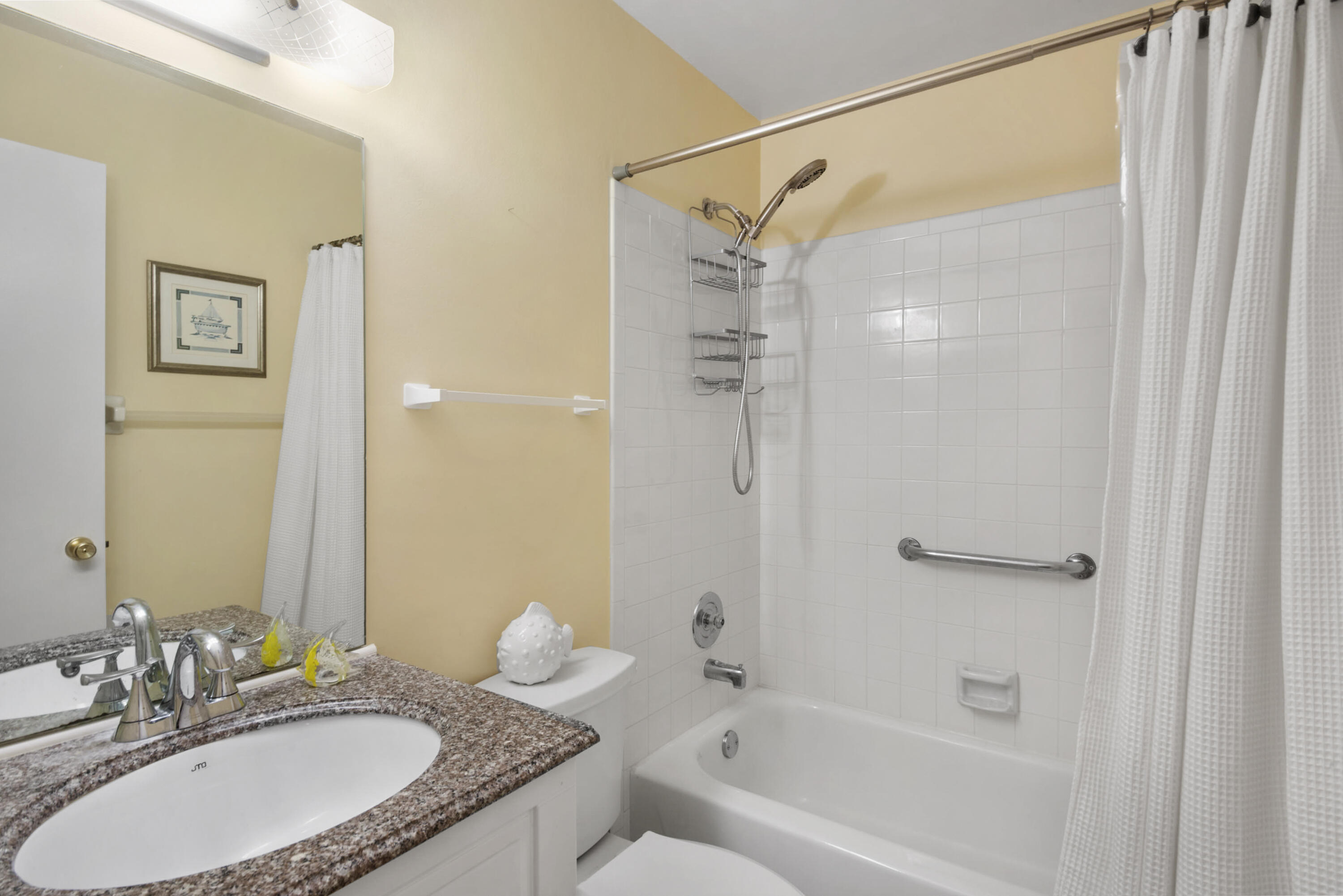 5222 Privet Place, Unit B Delray Beach, FL 33484 - Photo 20 of 27 a bathroom with a granite countertop sink a toilet and shower