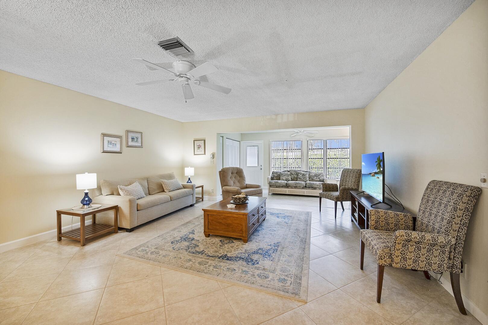 5222 Privet Place, Unit B Delray Beach, FL 33484 - Photo 2 of 27 a living room with furniture and a large window
