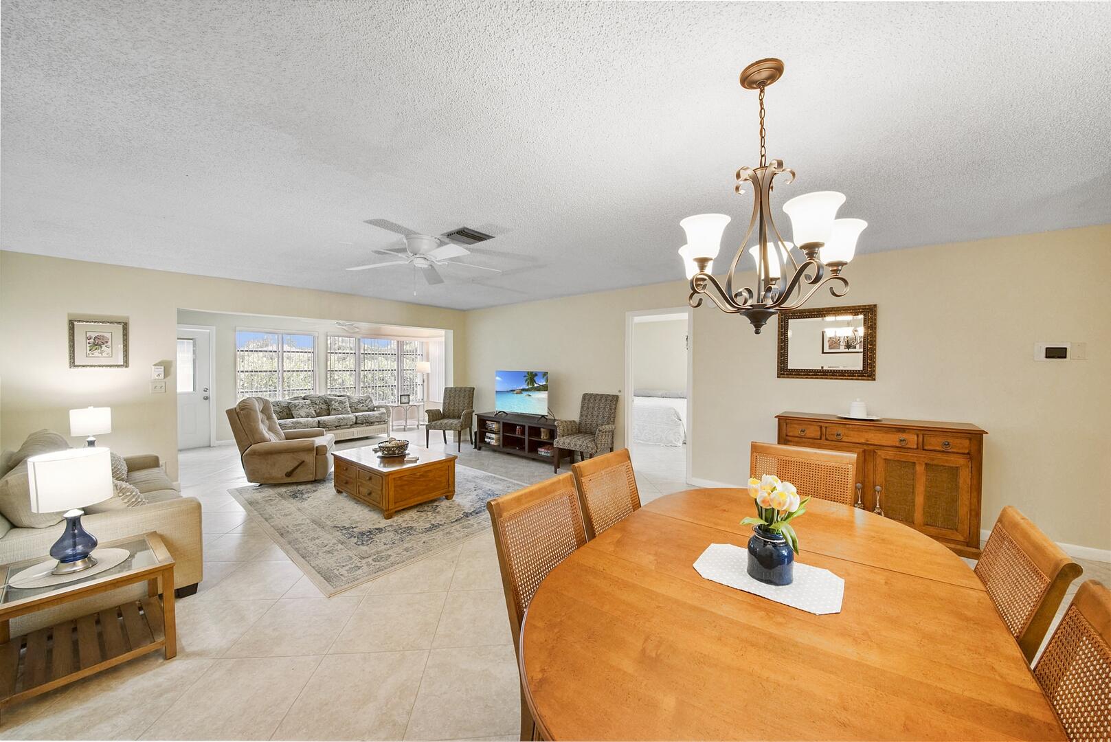 5222 Privet Place, Unit B Delray Beach, FL 33484 - Photo 4 of 27 a living room with furniture chandelier and a view of kitchen