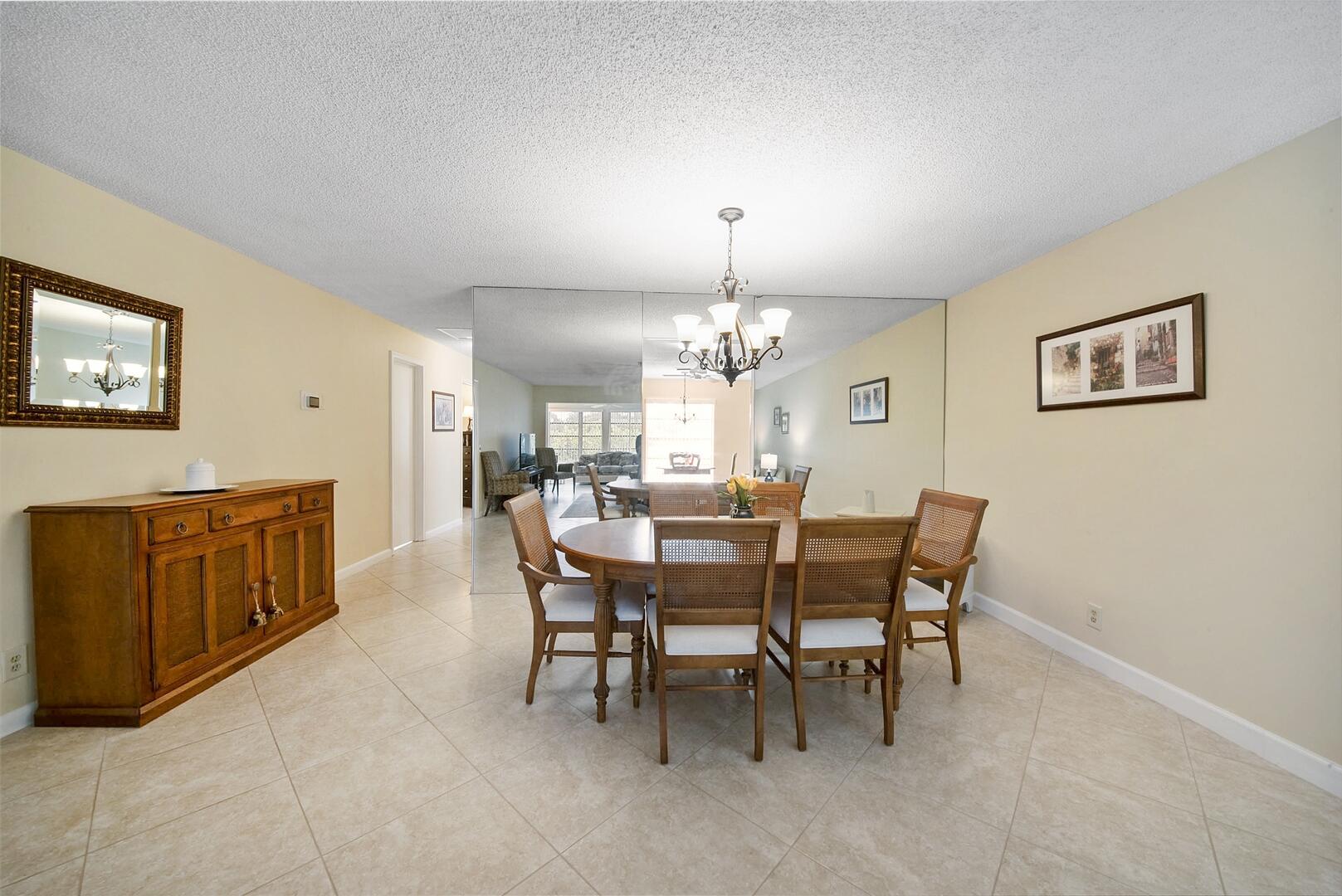 5222 Privet Place, Unit B Delray Beach, FL 33484 - Photo 5 of 27 a view of a dining room with furniture and chandelier