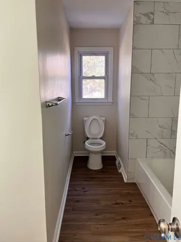 a bathroom with a toilet and a bathtub