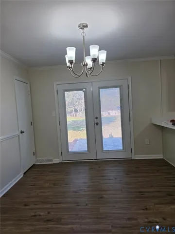 a view of wooden floor chandelier and wooden floor in a room