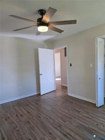 a view of an empty room and wooden floor