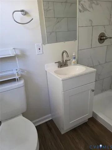 a bathroom with a toilet sink and vanity