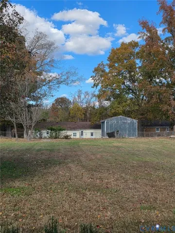 a view of a big yard with large trees