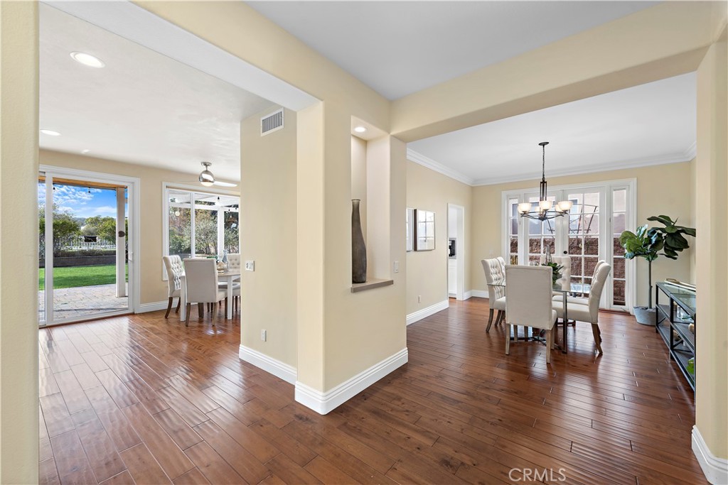 5 High Bluff Laguna Niguel, CA 92677 - Photo 11 of 64 a dining room with wooden floor a chandelier a glass table and chairs
