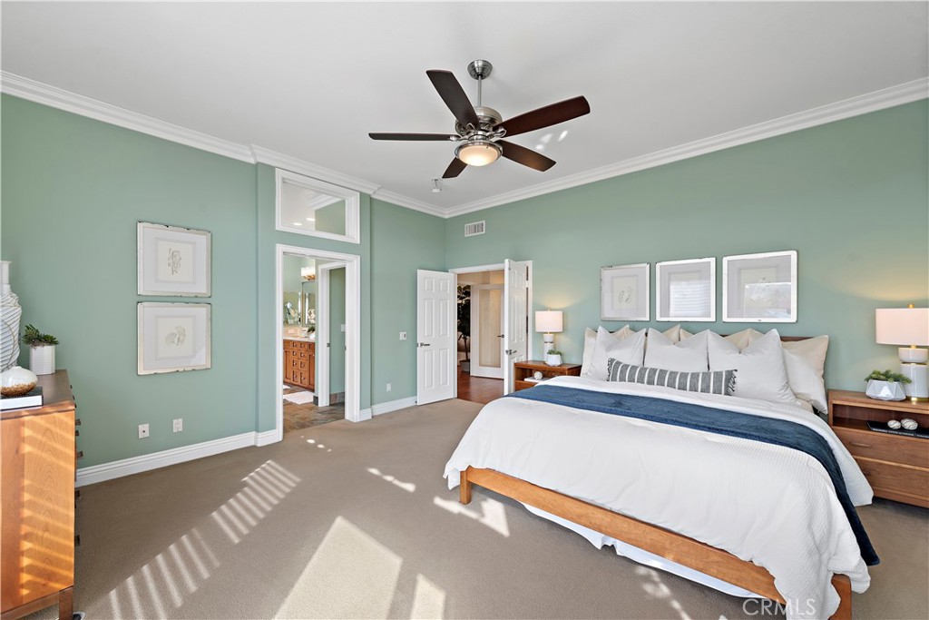 5 High Bluff Laguna Niguel, CA 92677 - Photo 19 of 64 a bedroom with a large bed and a chandelier