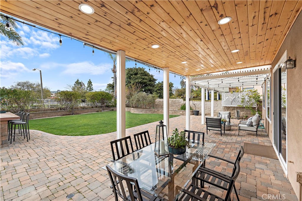 5 High Bluff Laguna Niguel, CA 92677 - Photo 31 of 64 a view of a patio with a table chairs and a backyard